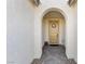 Inviting front entrance with an arched doorway and a stylish welcome sign at 6557 Corsari Ridge St, Las Vegas, NV 89166