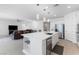 Open-concept kitchen with a large island, stainless steel appliances, and seamless flow to the living area at 6557 Corsari Ridge St, Las Vegas, NV 89166