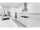 Bright, white kitchen featuring modern appliances and marble countertops at 6557 Corsari Ridge St, Las Vegas, NV 89166