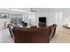 Spacious living room featuring an oversized leather sofa and ceiling fan at 6557 Corsari Ridge St, Las Vegas, NV 89166