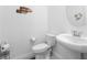 Compact powder room featuring a pedestal sink and modern toilet at 6557 Corsari Ridge St, Las Vegas, NV 89166