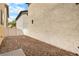 An empty backyard with gravel. This area offers a blank canvas for landscaping ideas at 6743 Windingwood St, Las Vegas, NV 89148