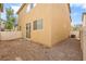 Corner view of the backyard featuring low maintenance gravel landscaping and a white fence at 6743 Windingwood St, Las Vegas, NV 89148