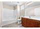 Well-lit bathroom with modern vanity, toilet, and shower-tub combination at 6743 Windingwood St, Las Vegas, NV 89148