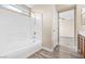 Bright bathroom featuring a white tub and shower combination with modern fixtures and stylish flooring at 6743 Windingwood St, Las Vegas, NV 89148