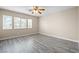 Spacious bedroom featuring laminate flooring, neutral walls, and large windows with ample natural light at 6743 Windingwood St, Las Vegas, NV 89148