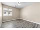 A bright bedroom with a ceiling fan and natural light streaming through the window at 6743 Windingwood St, Las Vegas, NV 89148