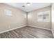 A comfortable bedroom with natural light, neutral walls, and attractive gray flooring at 6743 Windingwood St, Las Vegas, NV 89148