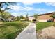 Scenic community greenspace with a walking path, lawns, trees, and benches at 6743 Windingwood St, Las Vegas, NV 89148