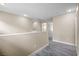 Open hallway with laminate flooring, neutral walls, and natural light creating a bright and inviting space at 6743 Windingwood St, Las Vegas, NV 89148