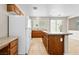 Open kitchen featuring essential appliances, granite countertops, and seamless access to adjacent spaces at 6743 Windingwood St, Las Vegas, NV 89148
