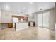 Open kitchen with essential appliances, center island, and sliding glass door access to the outside at 6743 Windingwood St, Las Vegas, NV 89148