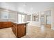 Open-concept kitchen island seamlessly connects kitchen and dining space, tiled floors throughout at 6743 Windingwood St, Las Vegas, NV 89148