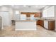 Functional kitchen with center island, essential appliances, and seamless flow into the living areas at 6743 Windingwood St, Las Vegas, NV 89148