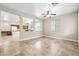 Bright living room with tile flooring and view into the kitchen, perfect for entertaining at 6743 Windingwood St, Las Vegas, NV 89148