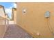Narrow side yard with low-maintenance gravel landscaping and beige exterior wall at 6743 Windingwood St, Las Vegas, NV 89148