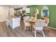 Charming dining area adjacent to the kitchen with a round table and stylish seating at 6957 Lynbridge St # 57, Las Vegas, NV 89166