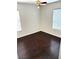 Cozy bedroom featuring hardwood floors, a ceiling fan, and window with blinds at 7351 San Pablin St, Las Vegas, NV 89139