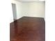 Open living room with hardwood floors, white walls, and baseboards. Perfect for entertaining at 7351 San Pablin St, Las Vegas, NV 89139