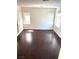 Large, light-filled living room with hardwood floors and multiple windows at 7351 San Pablin St, Las Vegas, NV 89139