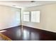 Spacious living room with hardwood floors and several windows for ample natural light at 7351 San Pablin St, Las Vegas, NV 89139