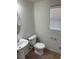 Clean powder room featuring a pedestal sink and toilet with tiled floors at 7351 San Pablin St, Las Vegas, NV 89139