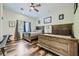 Bedroom showcasing two wood-framed beds, wood flooring, and a ceiling fan at 7760 Haven St, Las Vegas, NV 89123