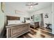Shared bedroom showcasing two wood-framed beds, wood flooring, and a ceiling fan at 7760 Haven St, Las Vegas, NV 89123