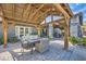 Relaxing covered patio with wood beams, comfortable seating and stone supports at 7760 Haven St, Las Vegas, NV 89123