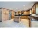 A modern kitchen with custom cabinetry, granite countertops, stainless steel appliances, and tile flooring at 7760 Haven St, Las Vegas, NV 89123