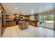 Spacious kitchen featuring tiled floors, stainless steel appliances and a center island at 7760 Haven St, Las Vegas, NV 89123