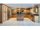 A bright, open kitchen with custom cabinetry, granite countertops, stainless steel appliances, and tile flooring at 7760 Haven St, Las Vegas, NV 89123