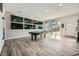 Spacious living area with a pool table and doors that bring in lots of natural light at 7760 Haven St, Las Vegas, NV 89123