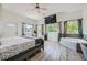 Bright main bedroom featuring natural light, a ceiling fan, and wood-look flooring at 7760 Haven St, Las Vegas, NV 89123