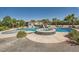 A backyard paradise featuring a sparkling pool with a waterfall, a spa, and lush tropical landscaping at 7760 Haven St, Las Vegas, NV 89123