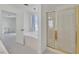 Bright bathroom featuring a glass door shower and separate tub with white tiling at 7925 Placid St, Las Vegas, NV 89123