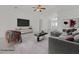 Bright, staged living room featuring vaulted ceilings, fan, decor, and modern furniture at 7925 Placid St, Las Vegas, NV 89123