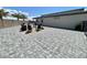 Expansive backyard with pavers, palm trees, and a fire pit area, perfect for entertaining at 7938 Jessamy St, North Las Vegas, NV 89084