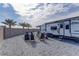 Spacious backyard patio with mountain views, pavers, RV parking and outdoor firepit with chairs at 7938 Jessamy St, North Las Vegas, NV 89084
