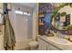 Charming bathroom featuring decorative mirror, tub, and unique accent wall at 7938 Jessamy St, North Las Vegas, NV 89084