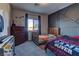 Bedroom with one bed, decorated black accent wall and natural light at 7938 Jessamy St, North Las Vegas, NV 89084