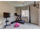 Bedroom with a treadmill, TV, and window allowing for natural light at 7938 Jessamy St, North Las Vegas, NV 89084