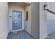 Welcoming front entry with a blue door, address plaque, stylish sidelights, and modern pavers at 7938 Jessamy St, North Las Vegas, NV 89084