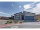 Contemporary home showing a modern desert landscape and concrete paved driveway to the attached garage at 7938 Jessamy St, North Las Vegas, NV 89084