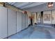 Well-organized garage with ample storage cabinets, art accents, and painted brick wall at 7938 Jessamy St, North Las Vegas, NV 89084