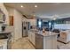Open layout kitchen with a granite island, stainless appliances, and views into the living area at 7938 Jessamy St, North Las Vegas, NV 89084