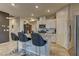 Bright kitchen featuring white cabinets, stainless steel appliances, granite countertops, and tile flooring at 7938 Jessamy St, North Las Vegas, NV 89084