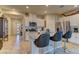 Open kitchen showcasing granite countertops, stainless steel appliances, and island with bar seating at 7938 Jessamy St, North Las Vegas, NV 89084
