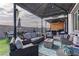 Outdoor living space with covered patio, seating, fire pit, and built in BBQ at 7938 Jessamy St, North Las Vegas, NV 89084