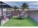 Inviting outdoor space featuring patio, seating area, artificial grass, and mountain views at 7938 Jessamy St, North Las Vegas, NV 89084